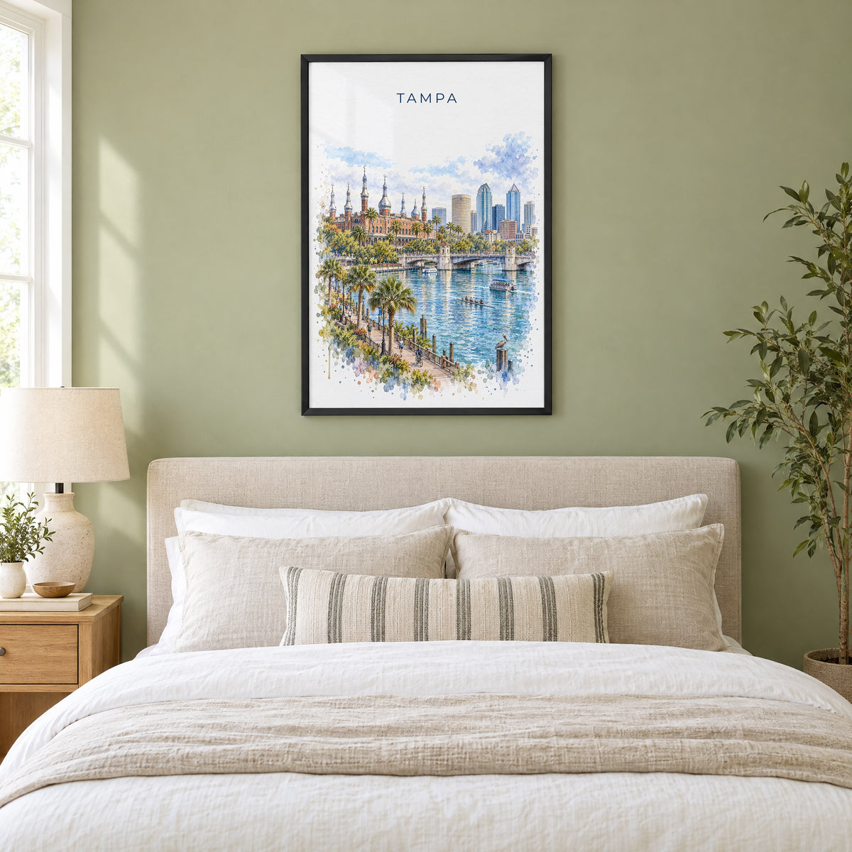Tampa watercolor print in a black frame above an upholstered headboard in a sage green bedroom