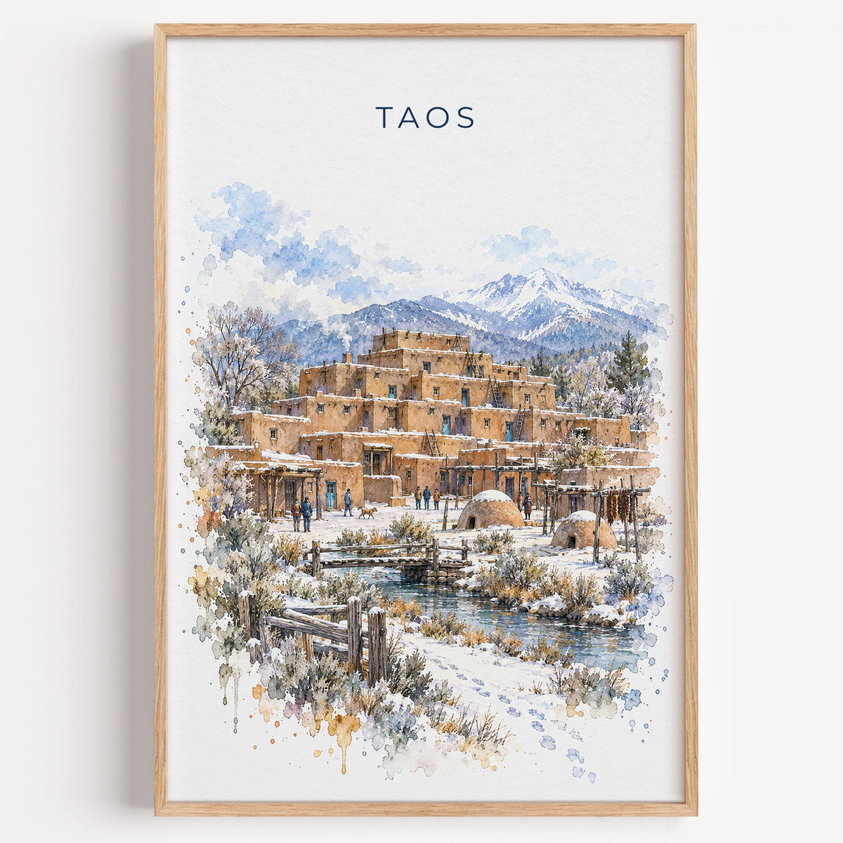 Taos watercolor print in a light oak frame on a plain white wall