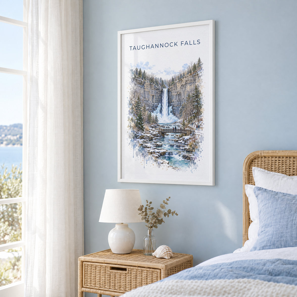 Taughannock Falls State Park watercolor print in a white frame on a pale blue wall beside a rattan bed in a coastal bedroom