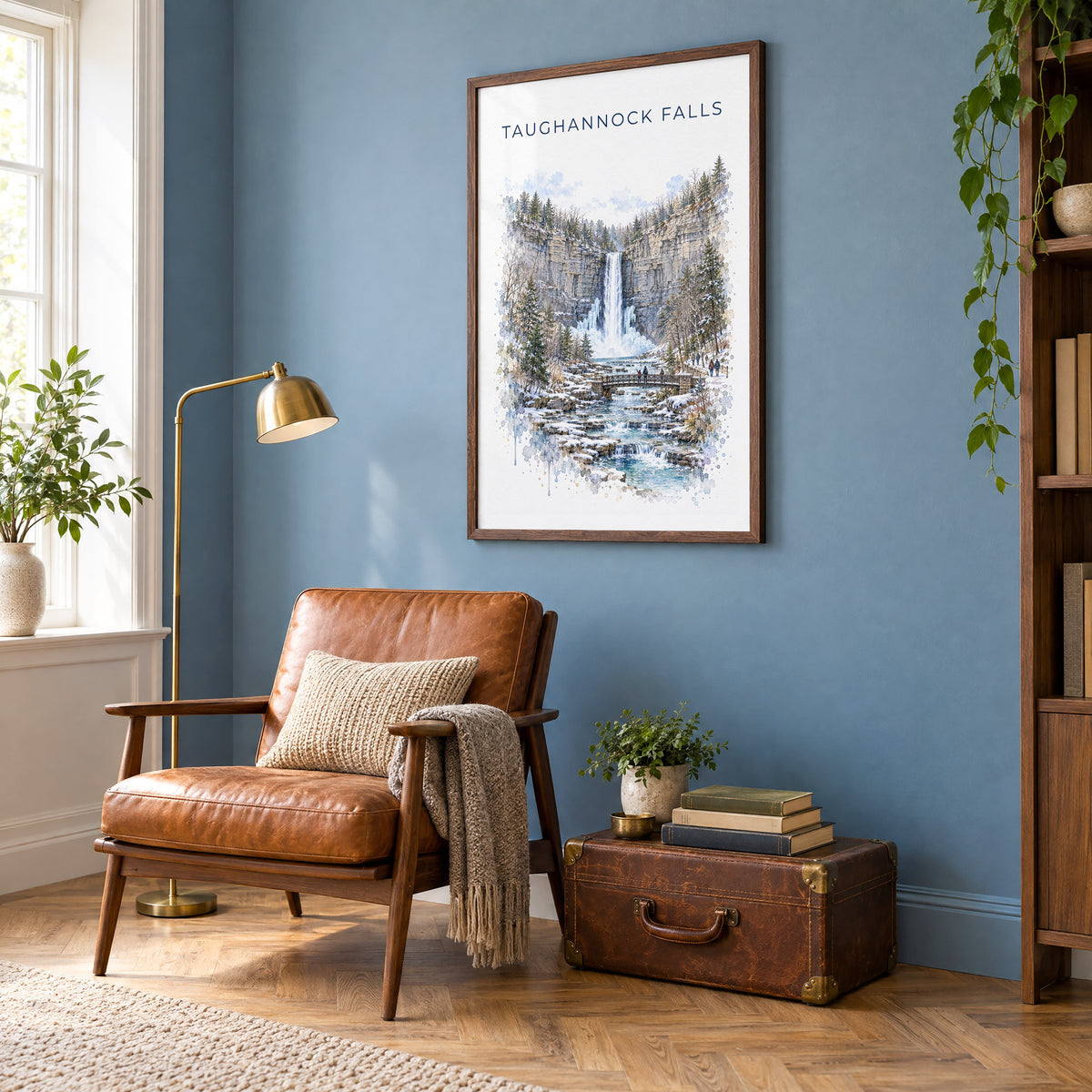 Taughannock Falls State Park watercolor print in a walnut frame on a blue wall above a leather armchair in a reading nook