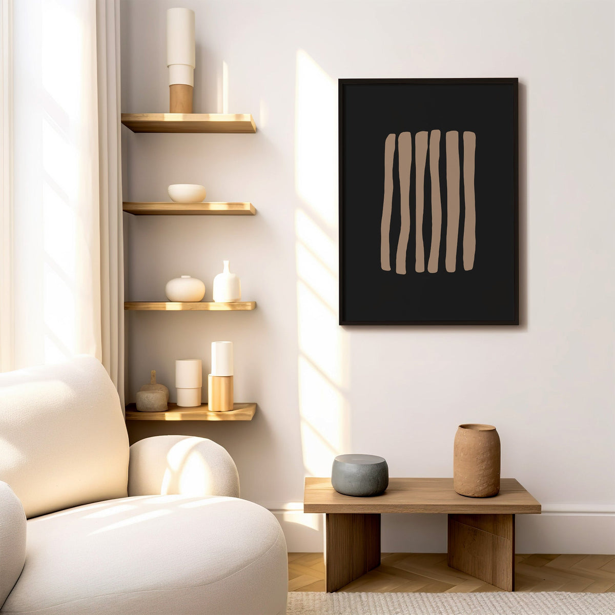 Taupe stripes on black background boho print in a black frame above a low wood bench beside floating oak shelves