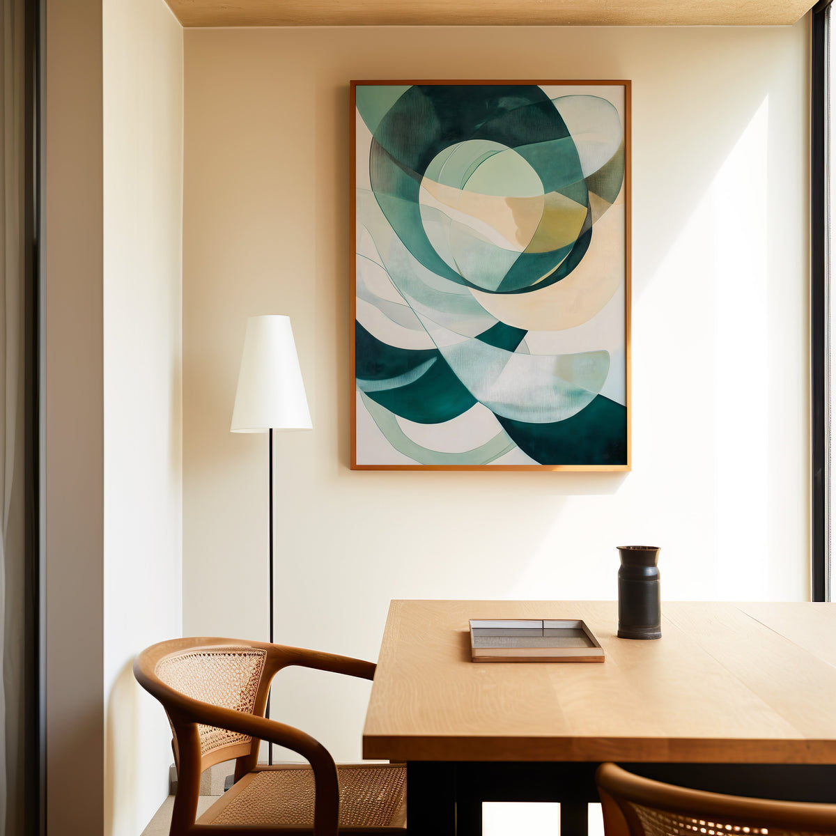 Teal and cream overlapping circles geometric print in a slim oak frame above a dining table with a cane-back chair