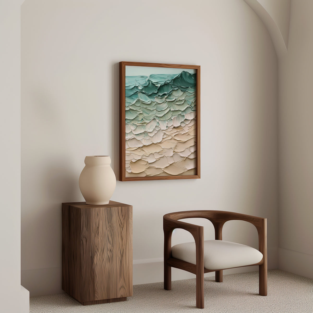 Teal and sand impasto shoreline abstract print in a walnut frame above a wood pedestal and a curved walnut armchair