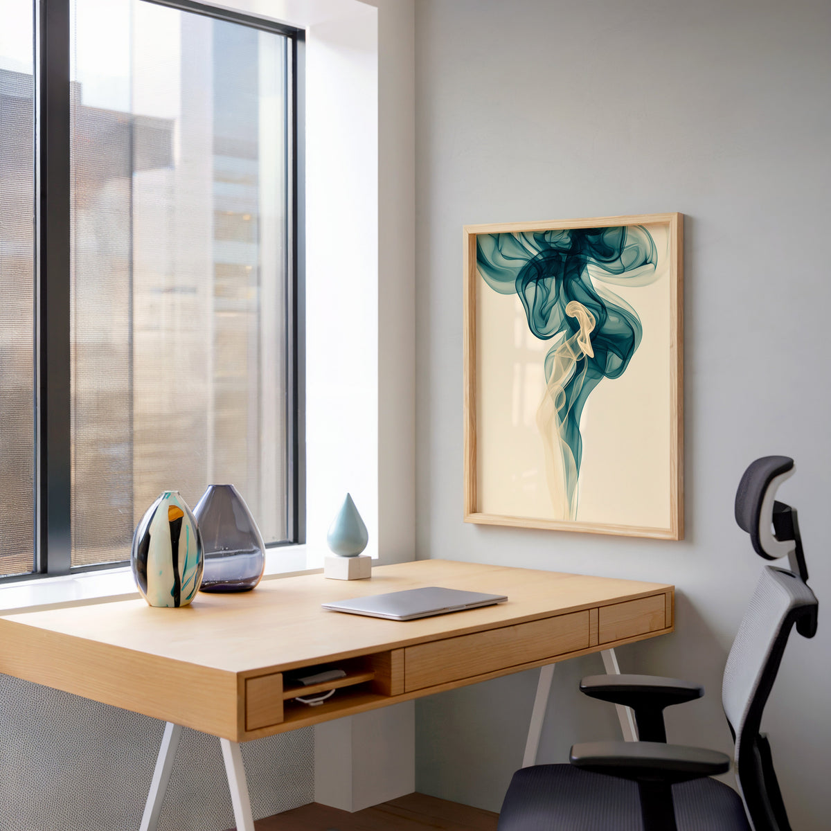 Teal smoke swirl fluid abstract print in a pale wood frame above a home office desk by a tall window