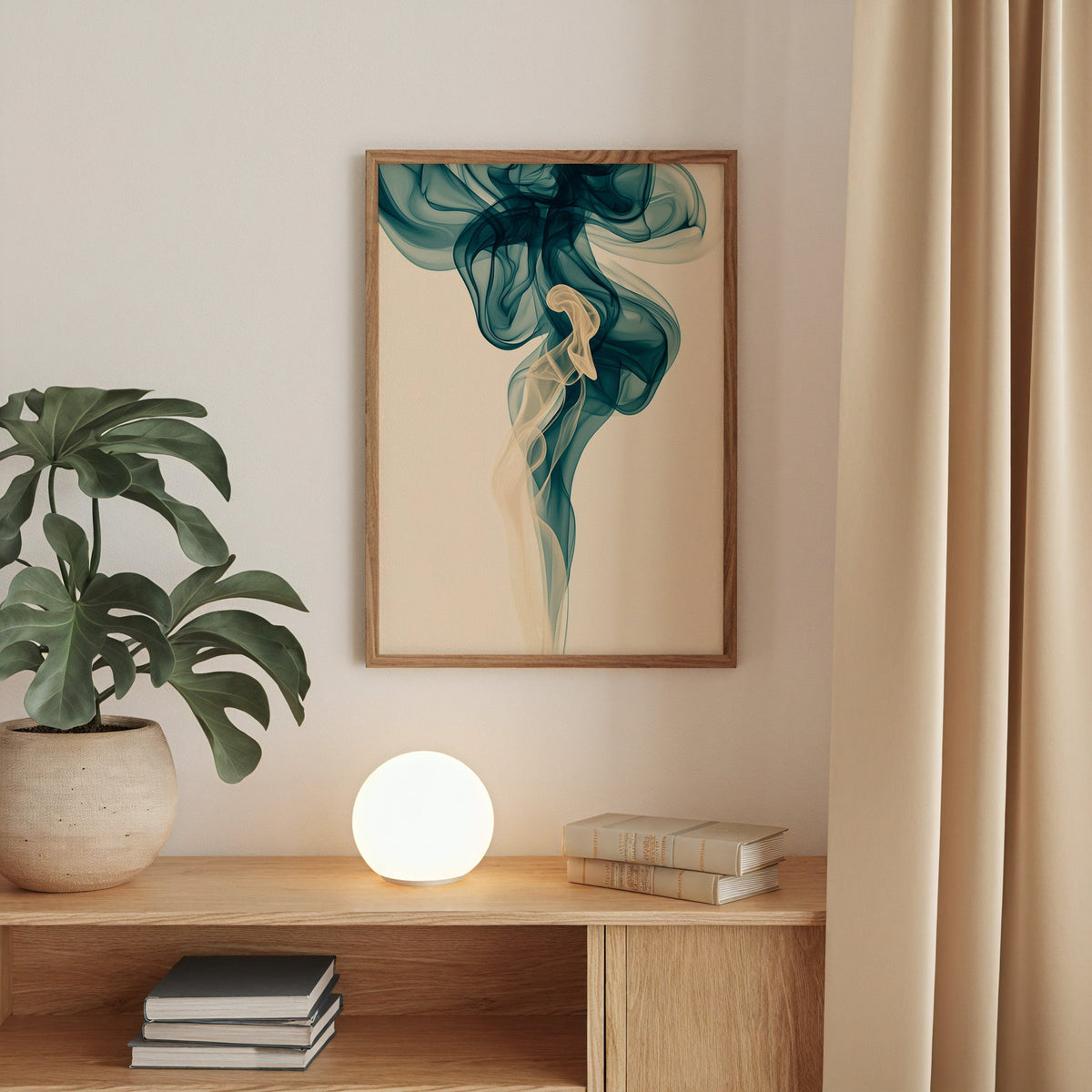Teal smoke swirl fluid abstract print in a walnut frame above an oak cabinet with a glowing globe lamp
