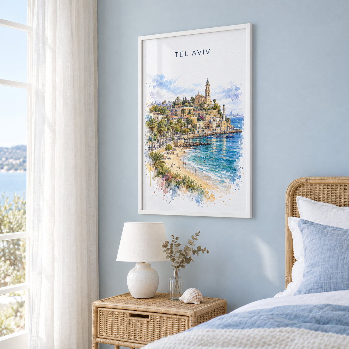 Tel Aviv watercolor print in a white frame on a pale blue wall beside a rattan bed in a coastal bedroom