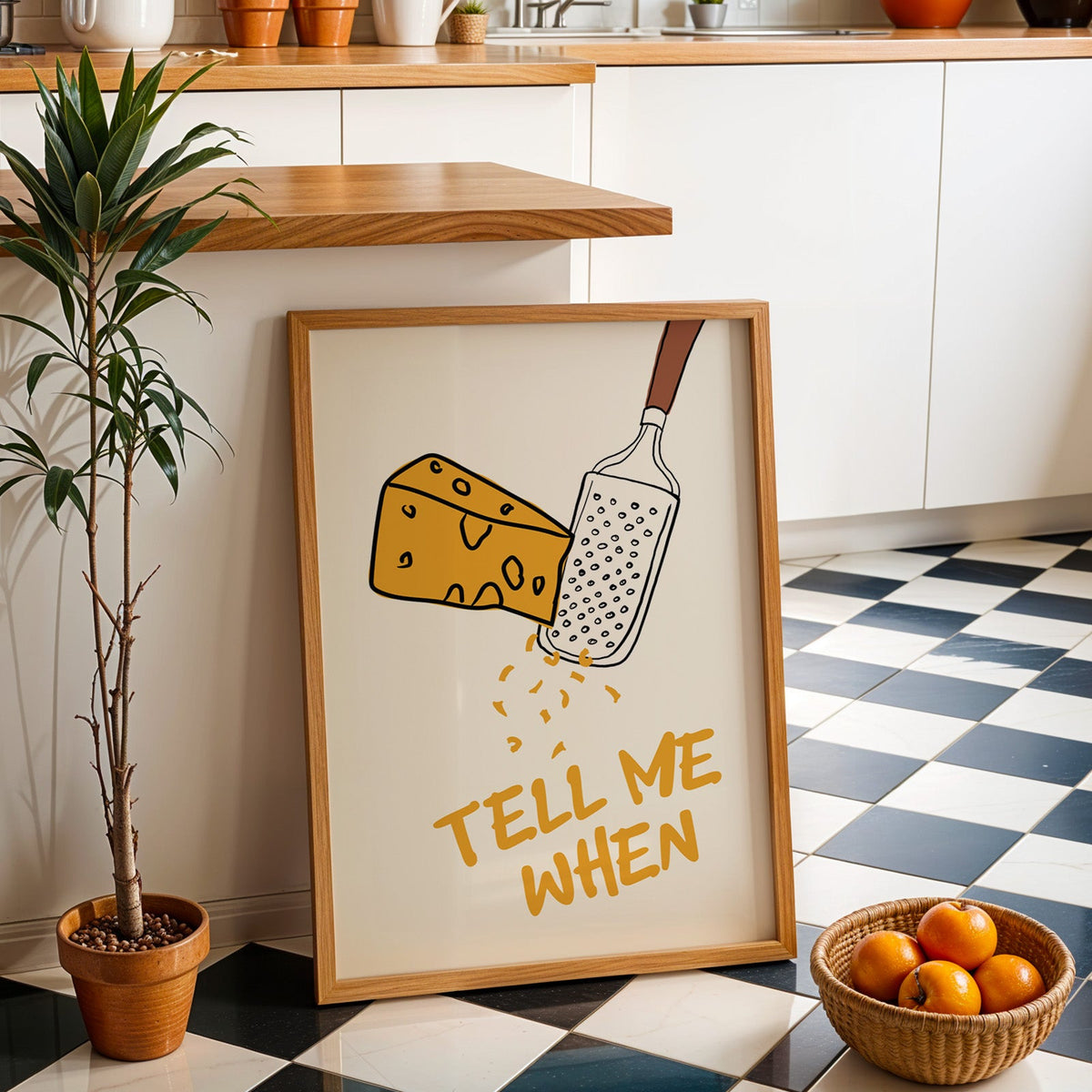 Tell me when cheese grater print in an oak frame by a kitchen island and tiled floor