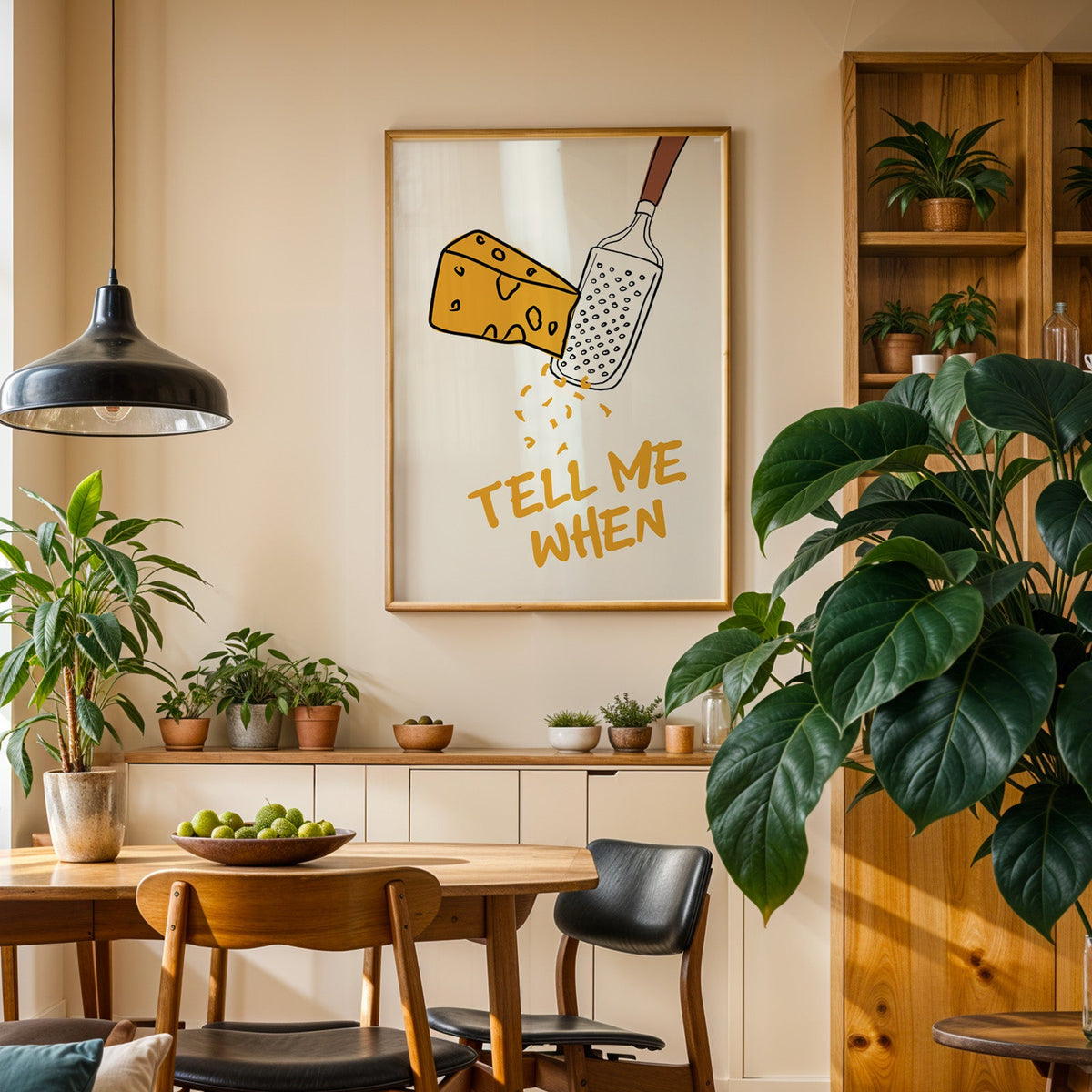 Tell me when cheese grater print in an oak frame above a sideboard in a dining room