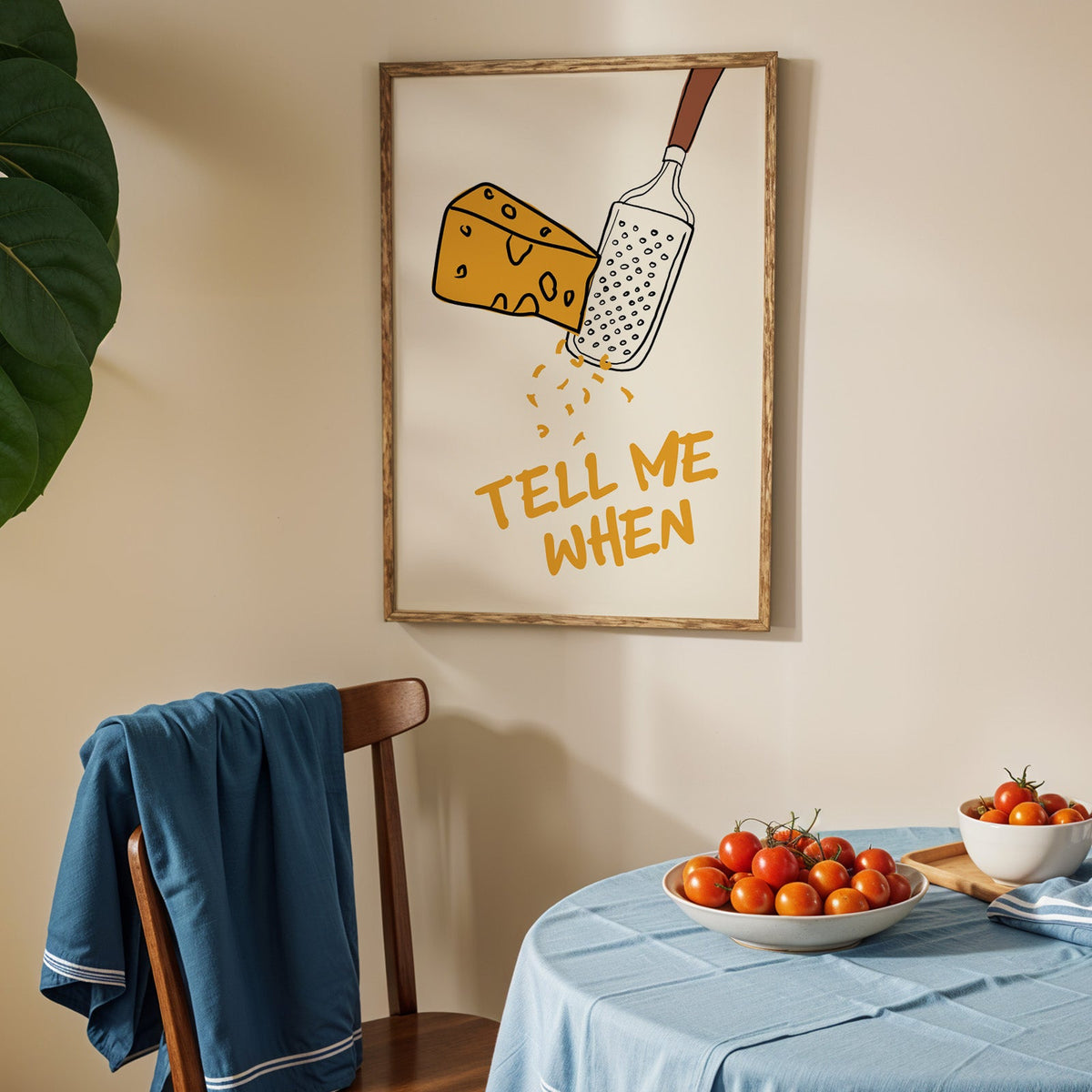 Tell me when cheese grater print in an oak frame above a blue linen table with tomatoes
