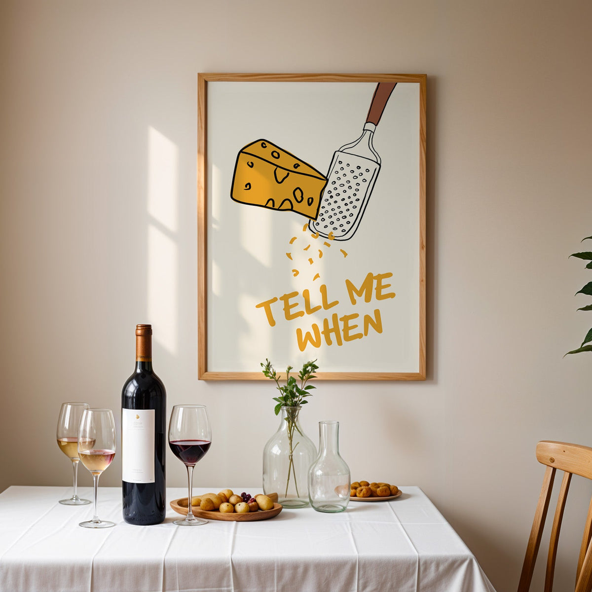 Tell me when cheese grater print in an oak frame above a table laid with red wine