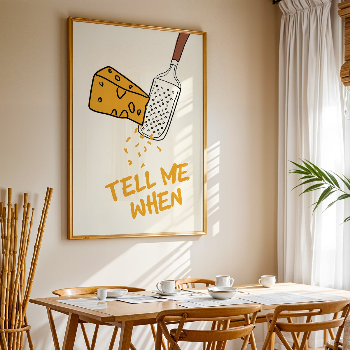 Tell me when cheese grater print in a gold frame above a sunlit breakfast table