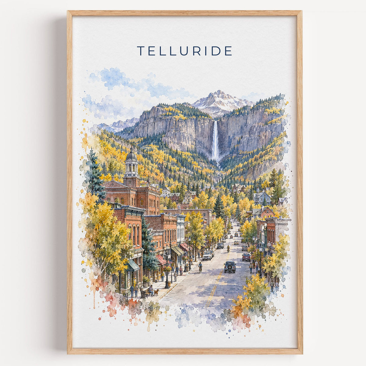 Telluride watercolor print in a light oak frame on a plain white wall