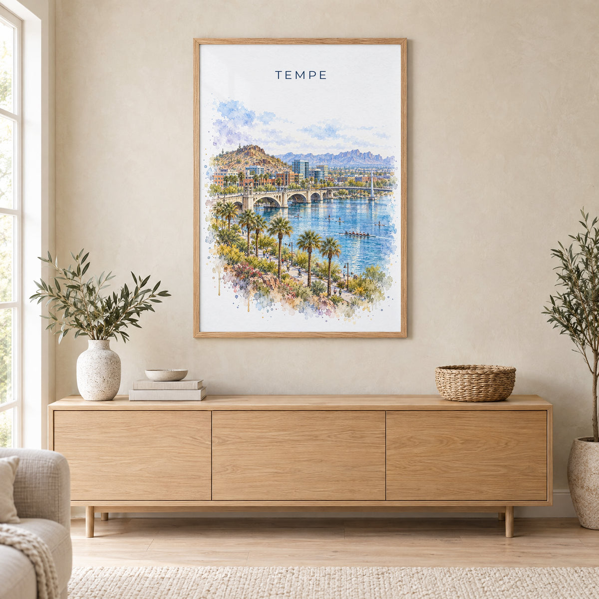 Tempe watercolor print in an oak frame above a light wood sideboard in a Scandinavian living room