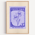 Tennessee state flower stamp print in indigo on periwinkle, light oak frame on a plain white wall