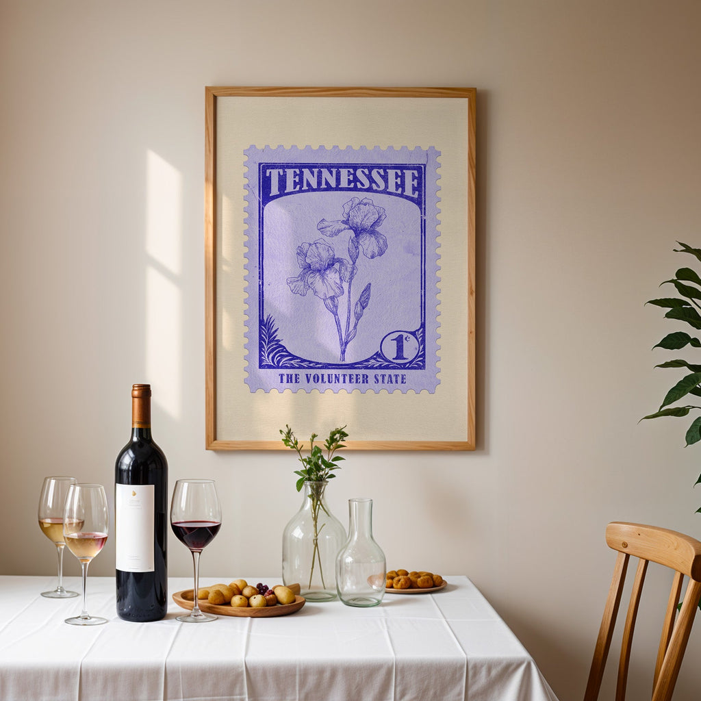 Tennessee stamp print framed on the wall above a dining table set with wine, glasses and olives