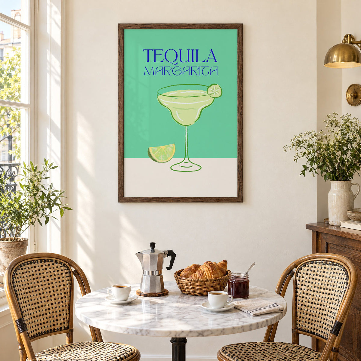 TEQUILA MARGARITA green glass and lime print in a walnut frame above a marble bistro table with croissants and rattan chairs