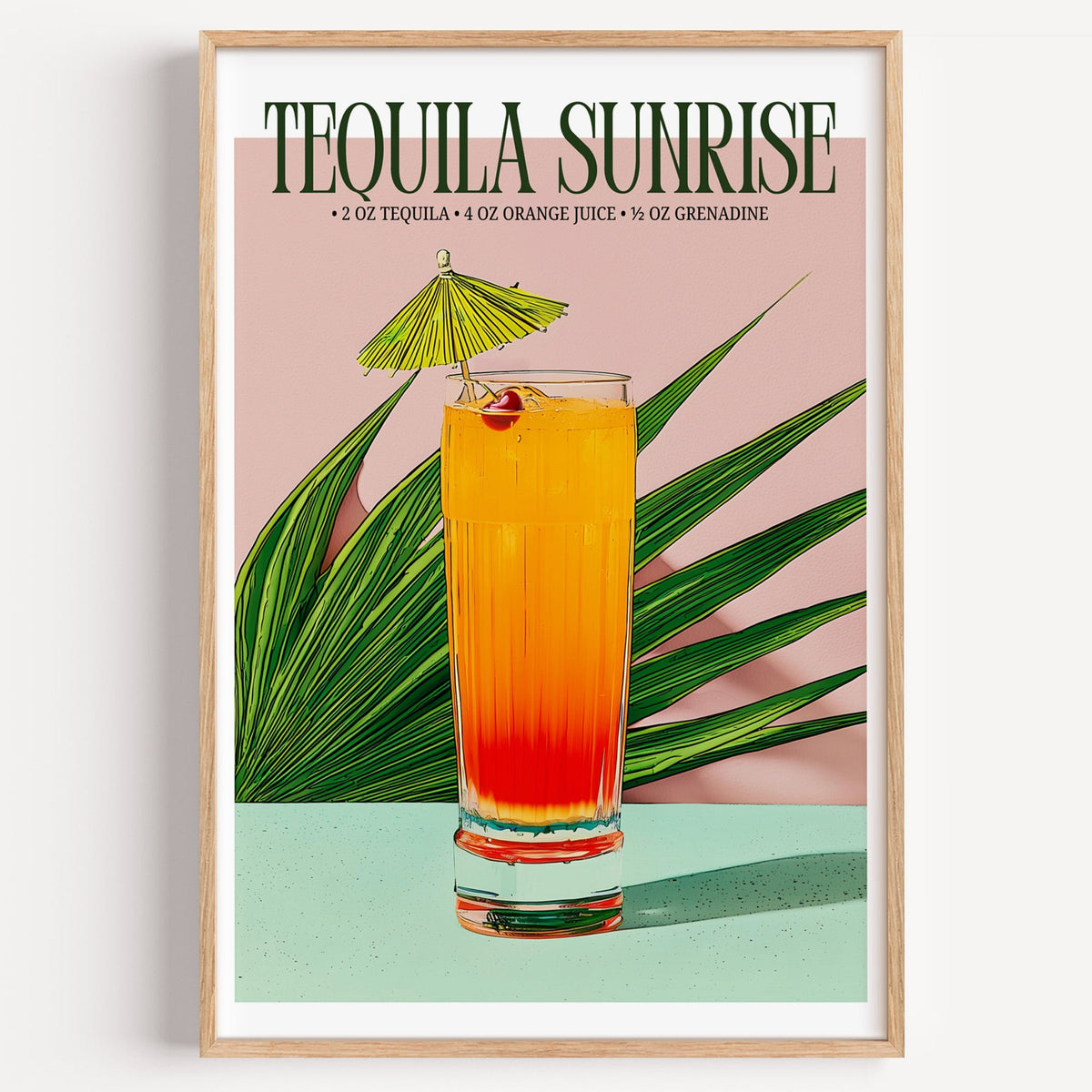Tequila sunrise recipe print in a light oak frame on a plain white wall