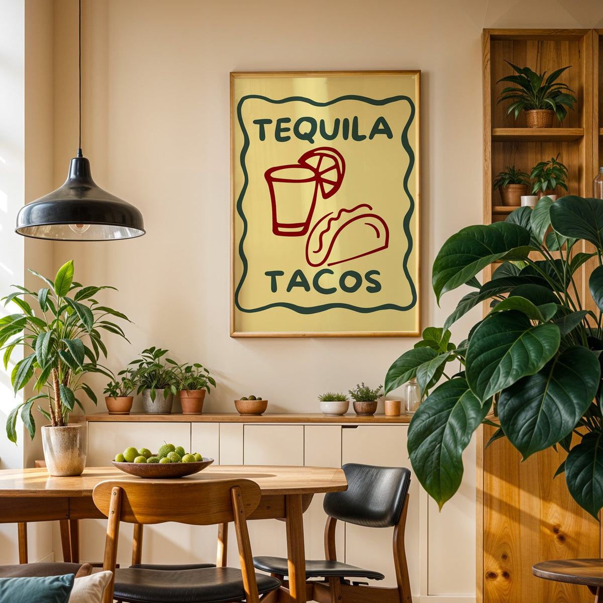 Tequila Tacos print in an oak frame in a dining room above a plant-lined sideboard