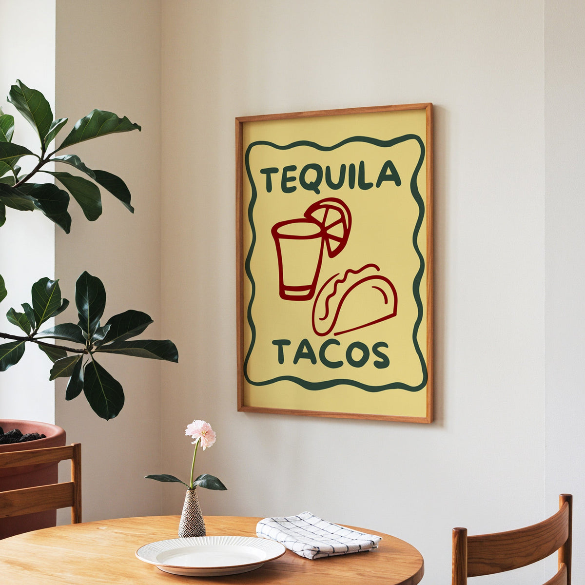 Tequila Tacos print in a walnut frame above a round table beside a fiddle-leaf fig