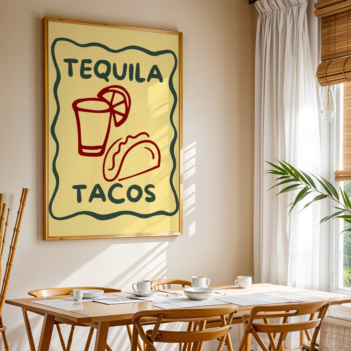 Tequila Tacos print shown in a gold frame above a breakfast table by a curtained window