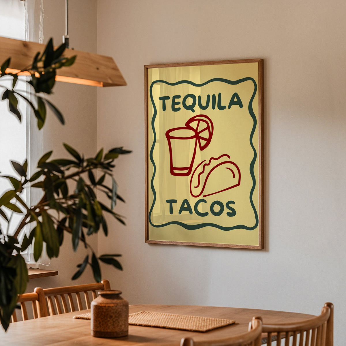Tequila Tacos print in a walnut frame above a dining table with olive branches