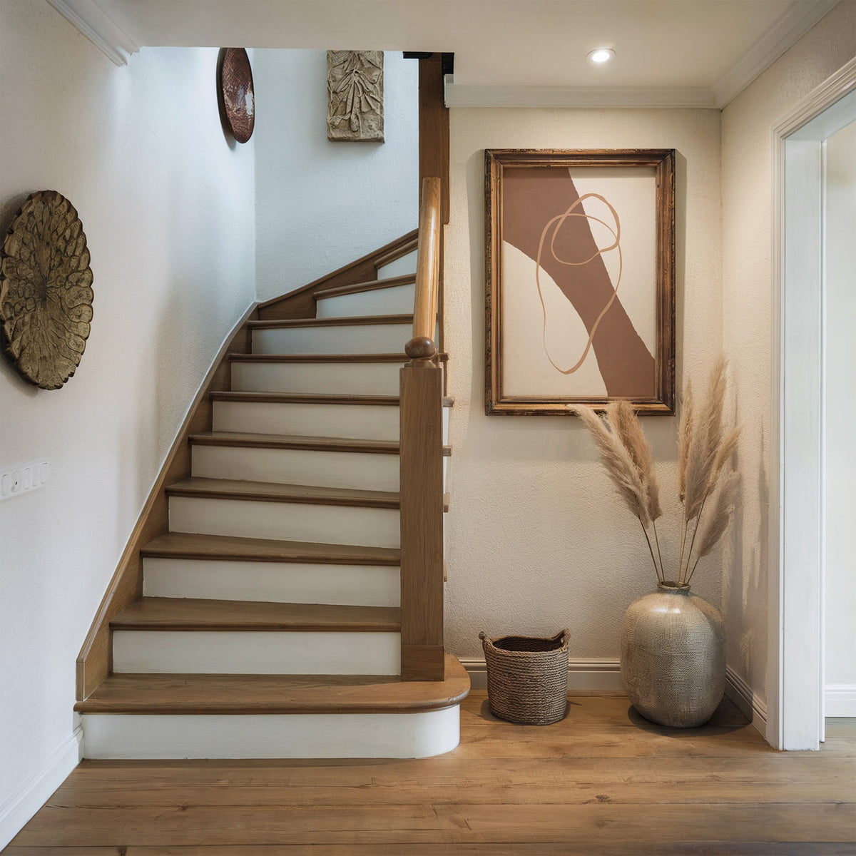 Terracotta diagonal band and loop line print shown in a rustic wood frame in a hallway beside a wooden staircase