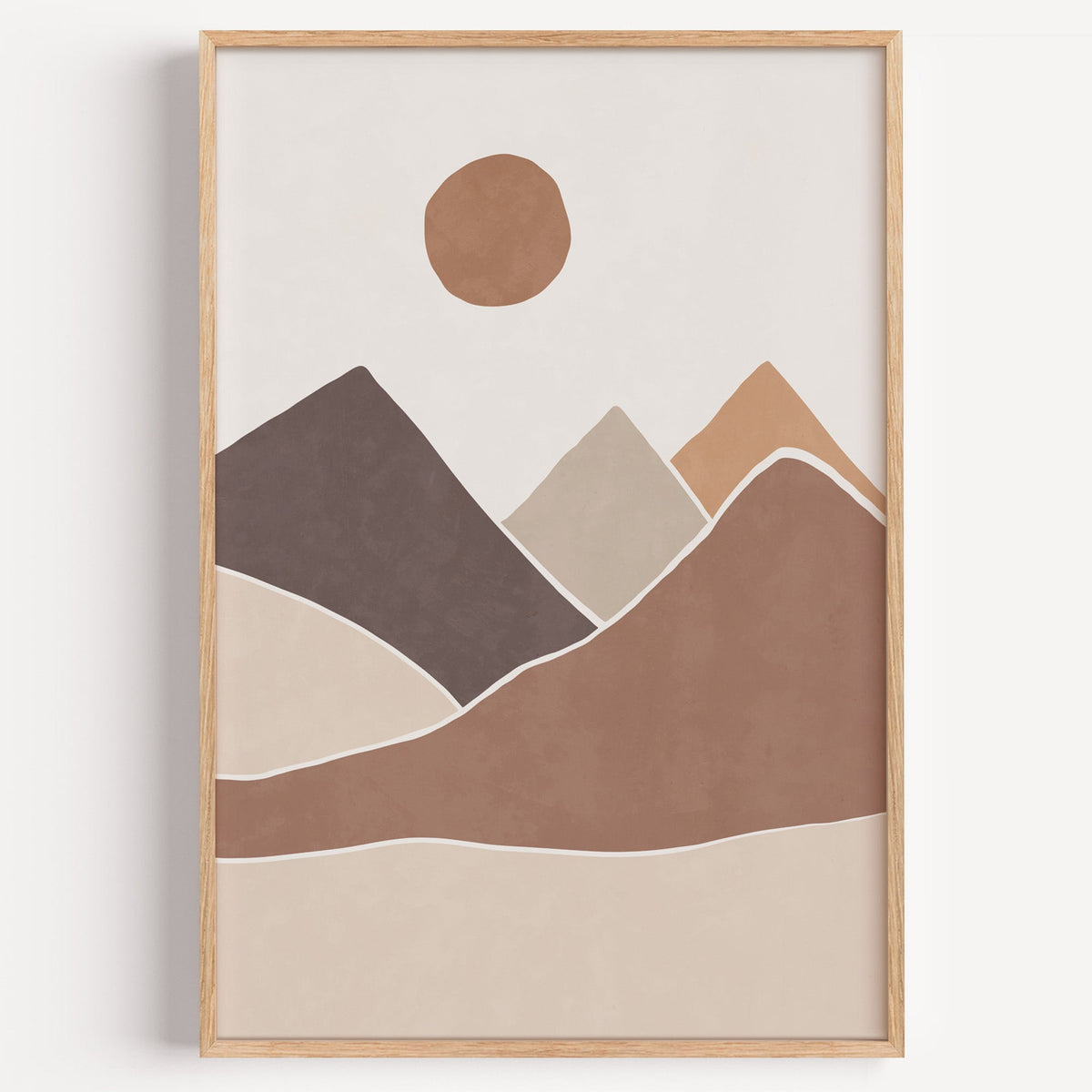 Terracotta sun over earth-tone mountains boho print in a light oak frame on a plain white wall