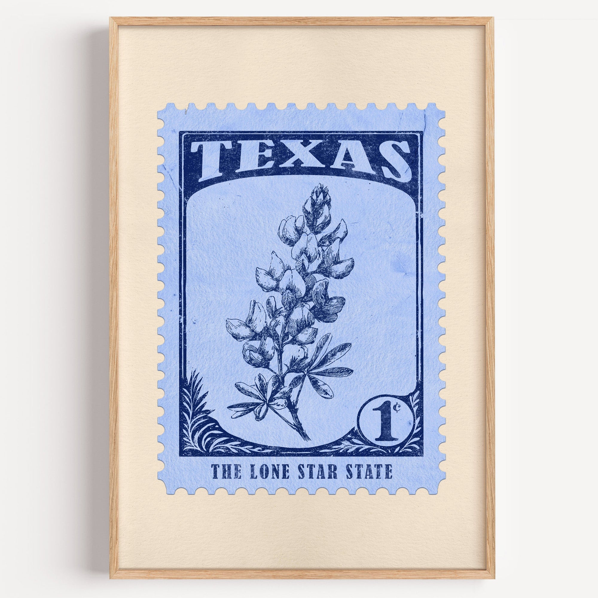 Texas state flower stamp print in navy on light blue, light oak frame on a plain white wall