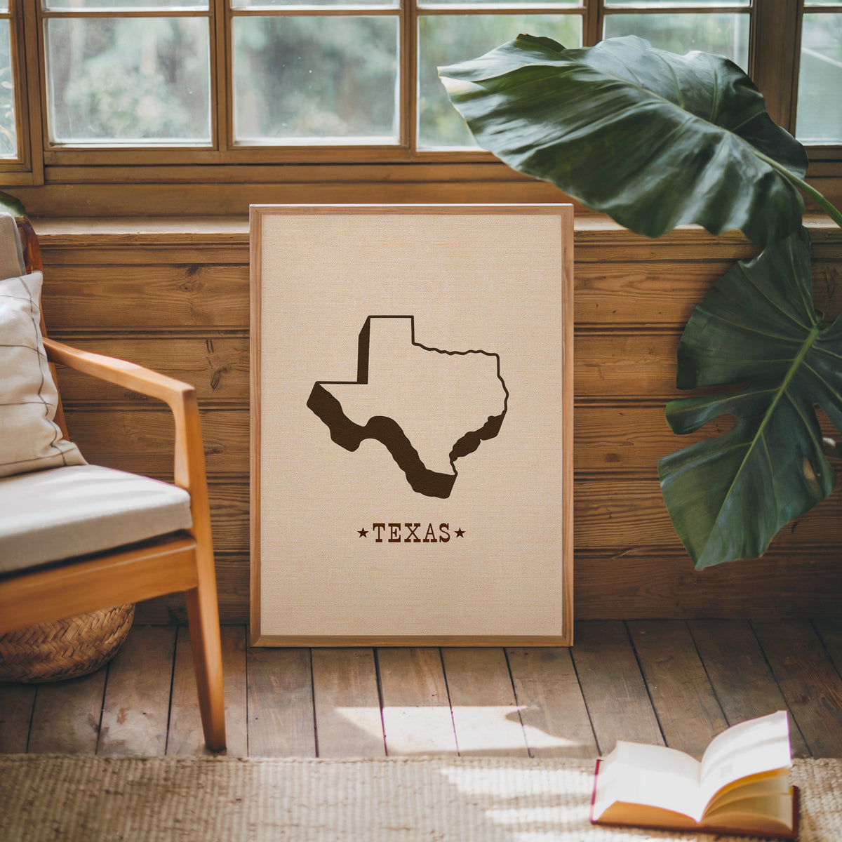 Texas state map print in an oak frame against a wood panel cabin wall
