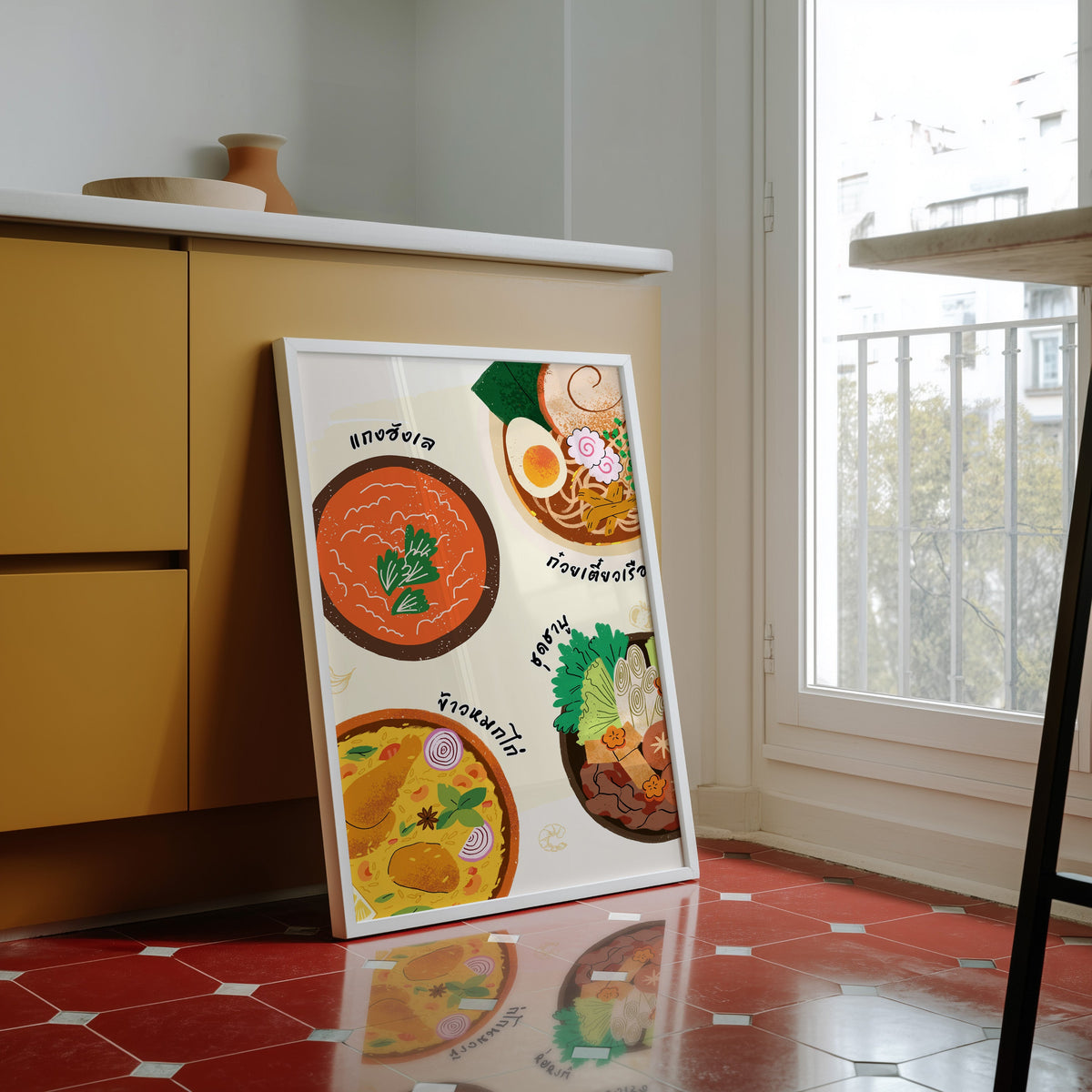 Thai food bowls print in a white frame against yellow cabinets on a red tiled floor