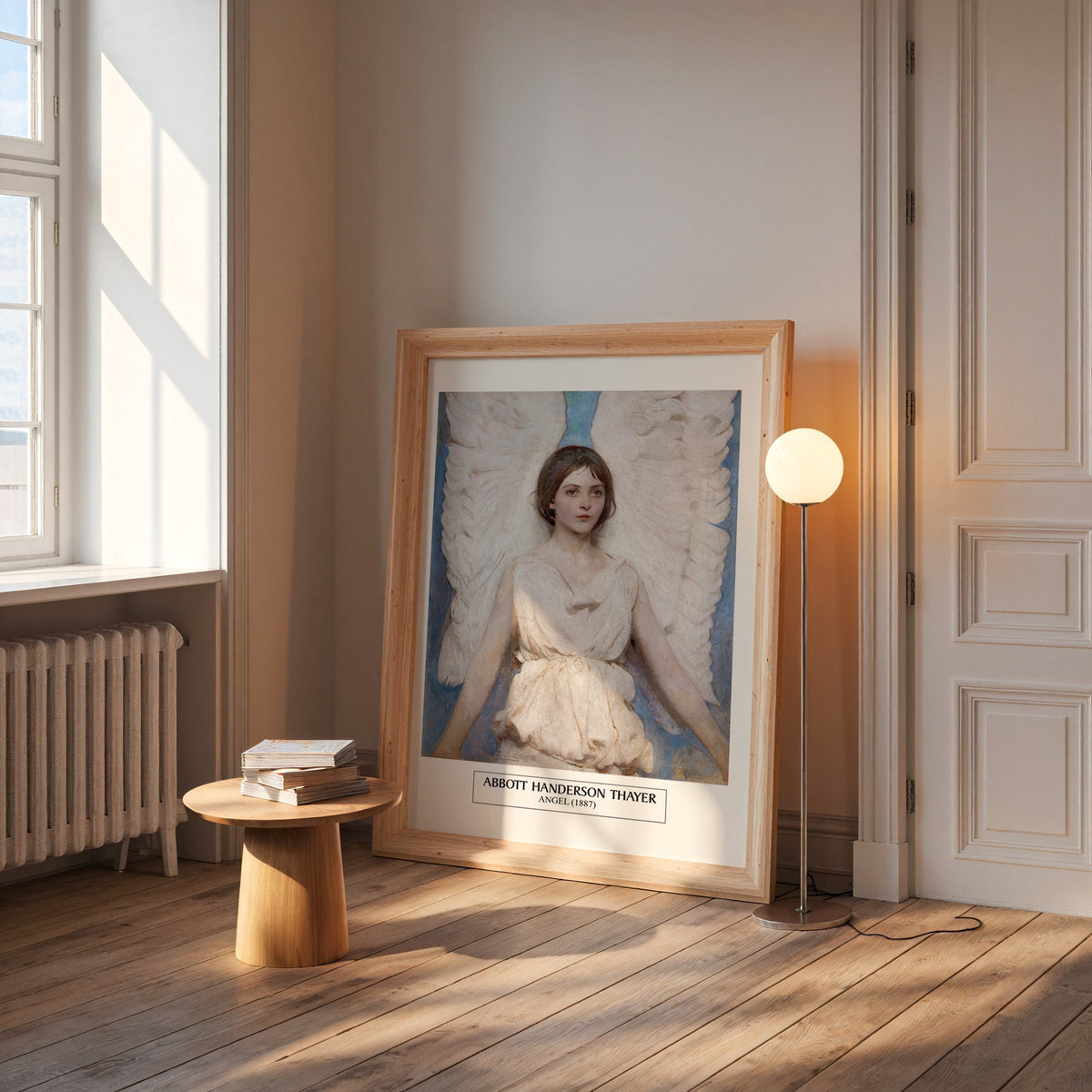 Angel print in a wide pine frame leaning by a sunlit window