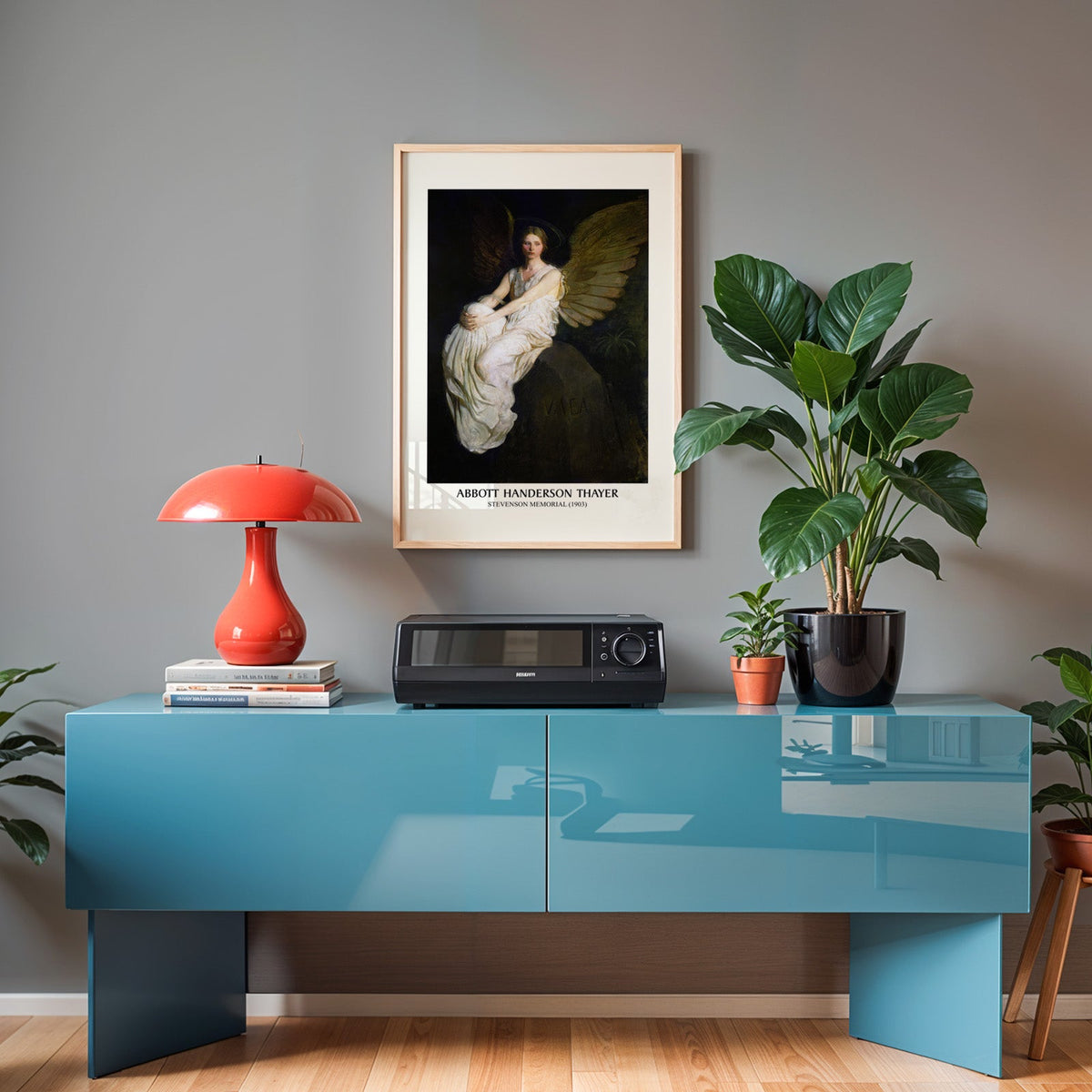 Stevenson Memorial poster in an oak frame above a teal sideboard with a red lamp