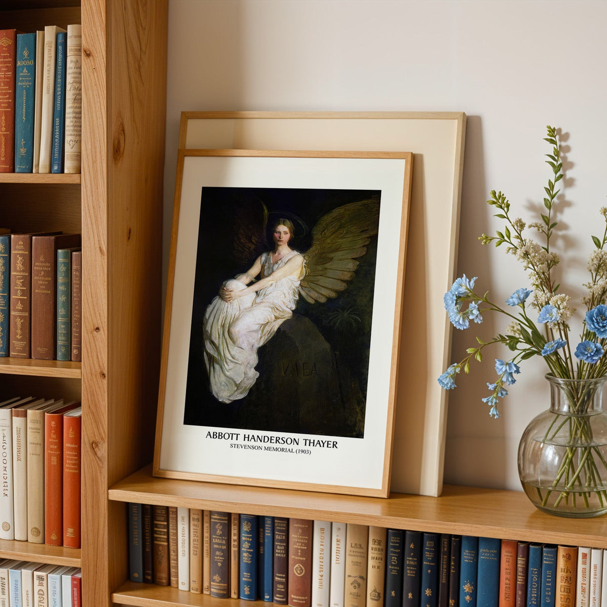 Stevenson Memorial print in an oak frame leaning on a bookshelf beside flowers