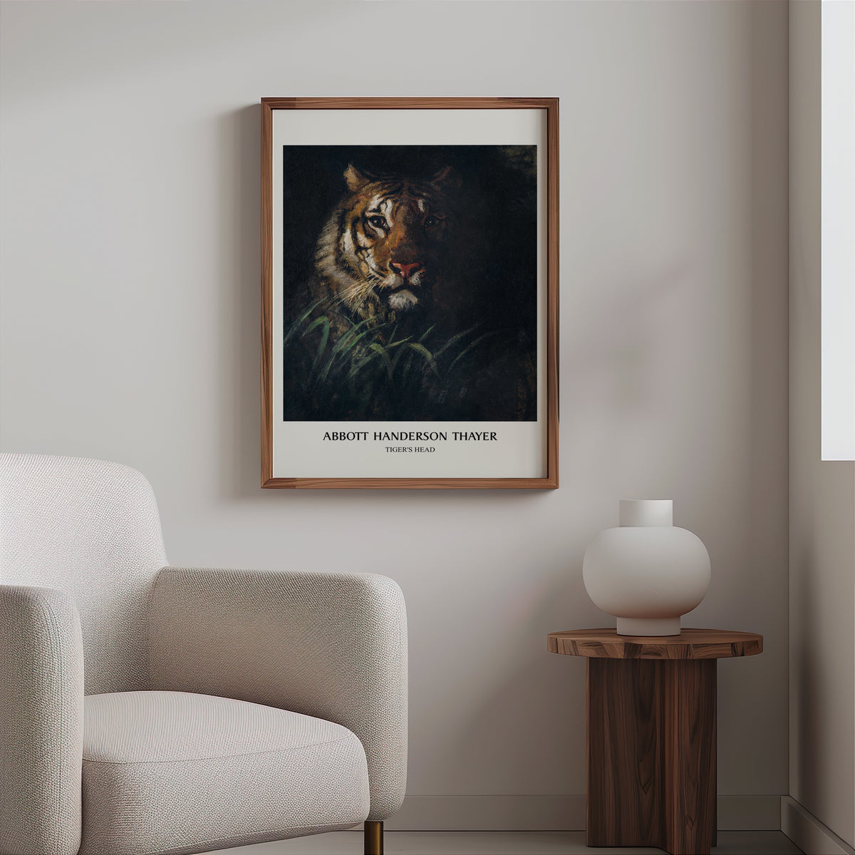 Tiger painting print in a slim walnut frame above a bouclé armchair