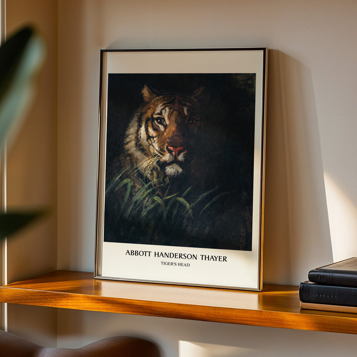 Tiger painting in a black frame on a walnut shelf in warm evening light