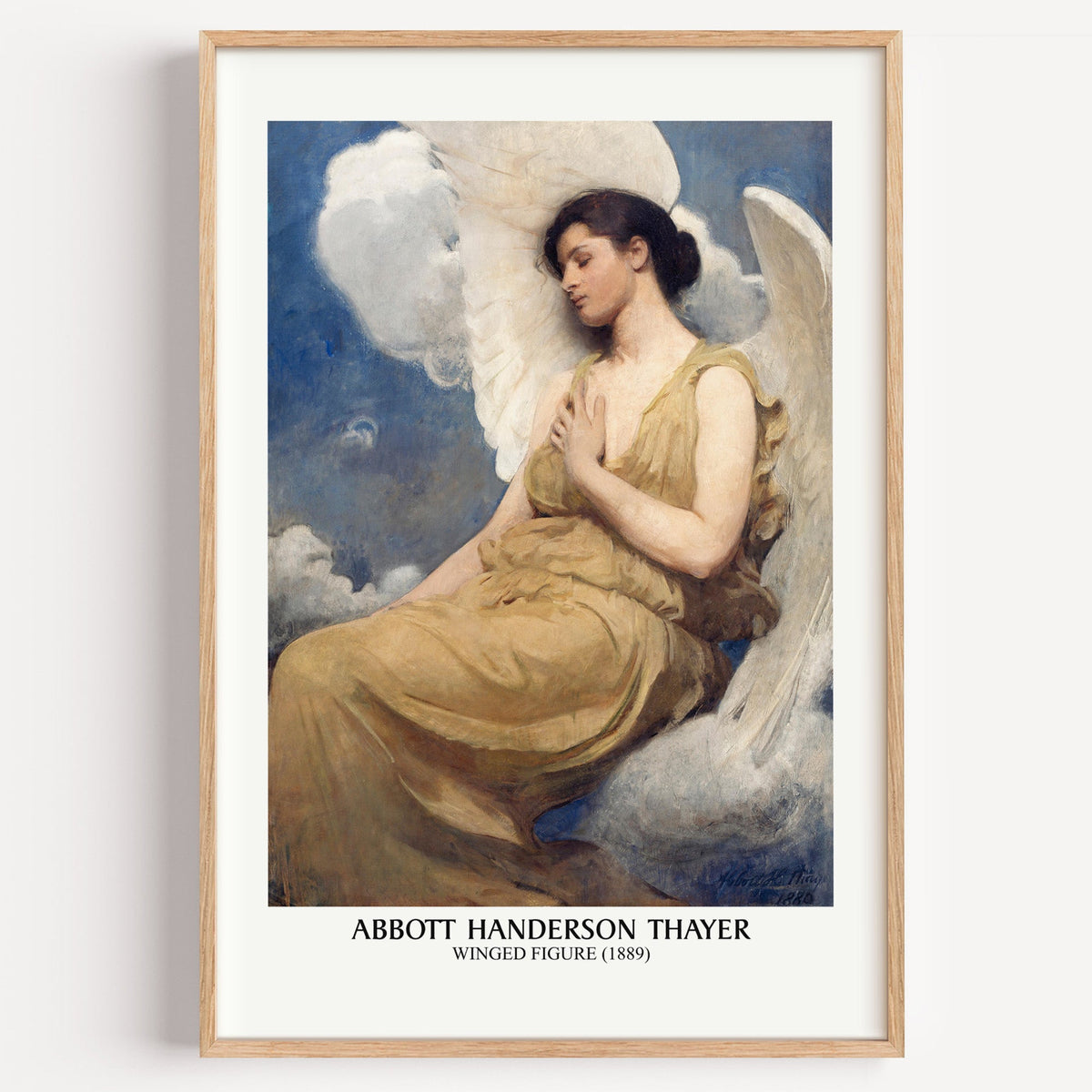 Abbott Thayer Winged Figure print in a light oak frame on a plain white wall