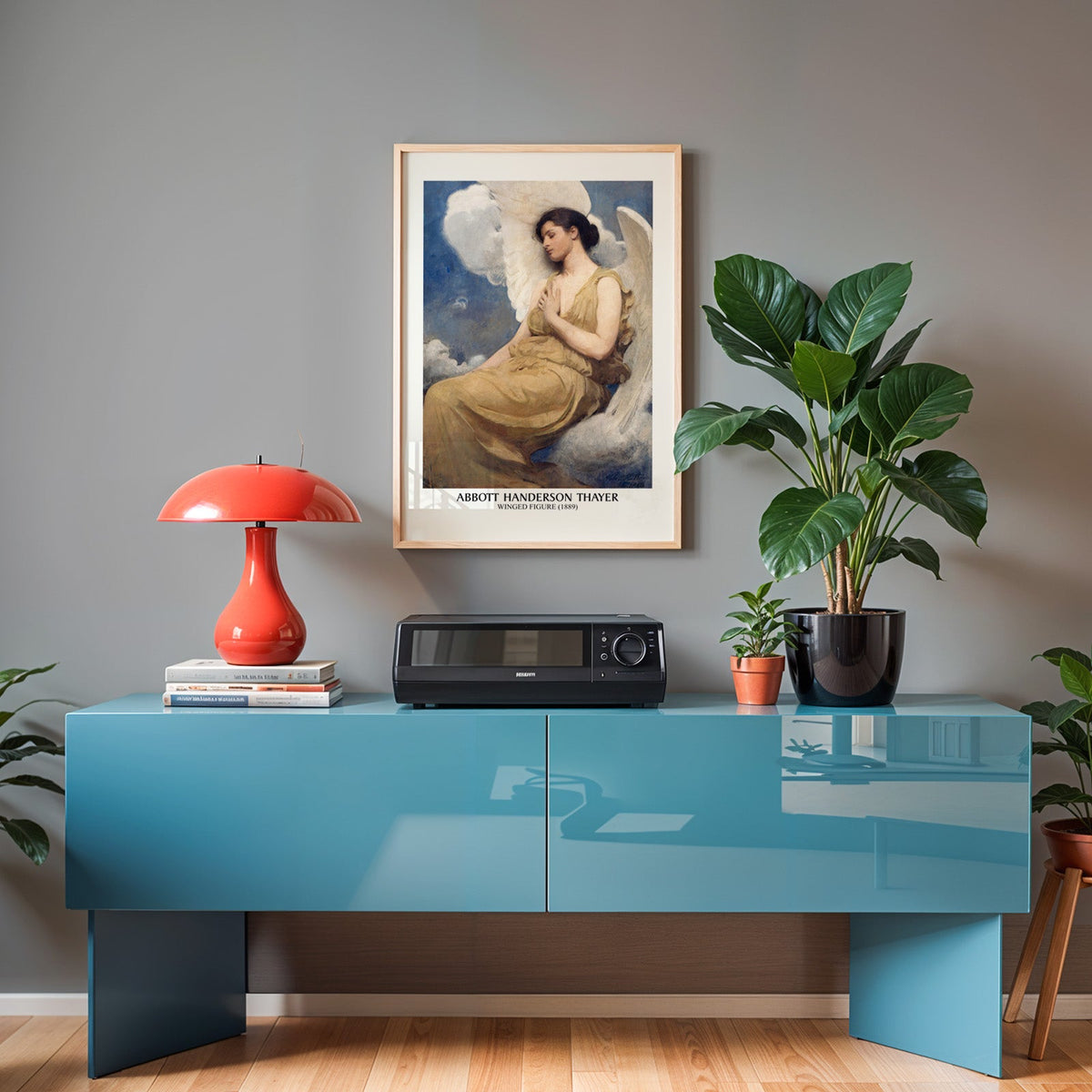 Thayer poster in an oak frame above a teal sideboard with a red lamp
