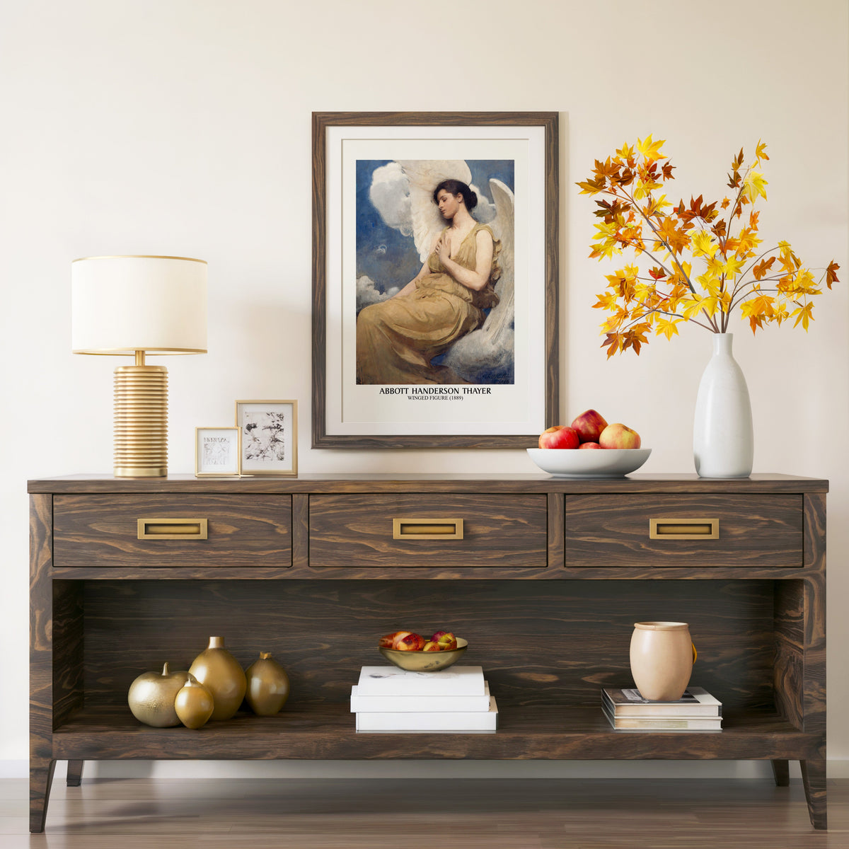 Winged Figure print in a walnut frame above a console with autumn branches