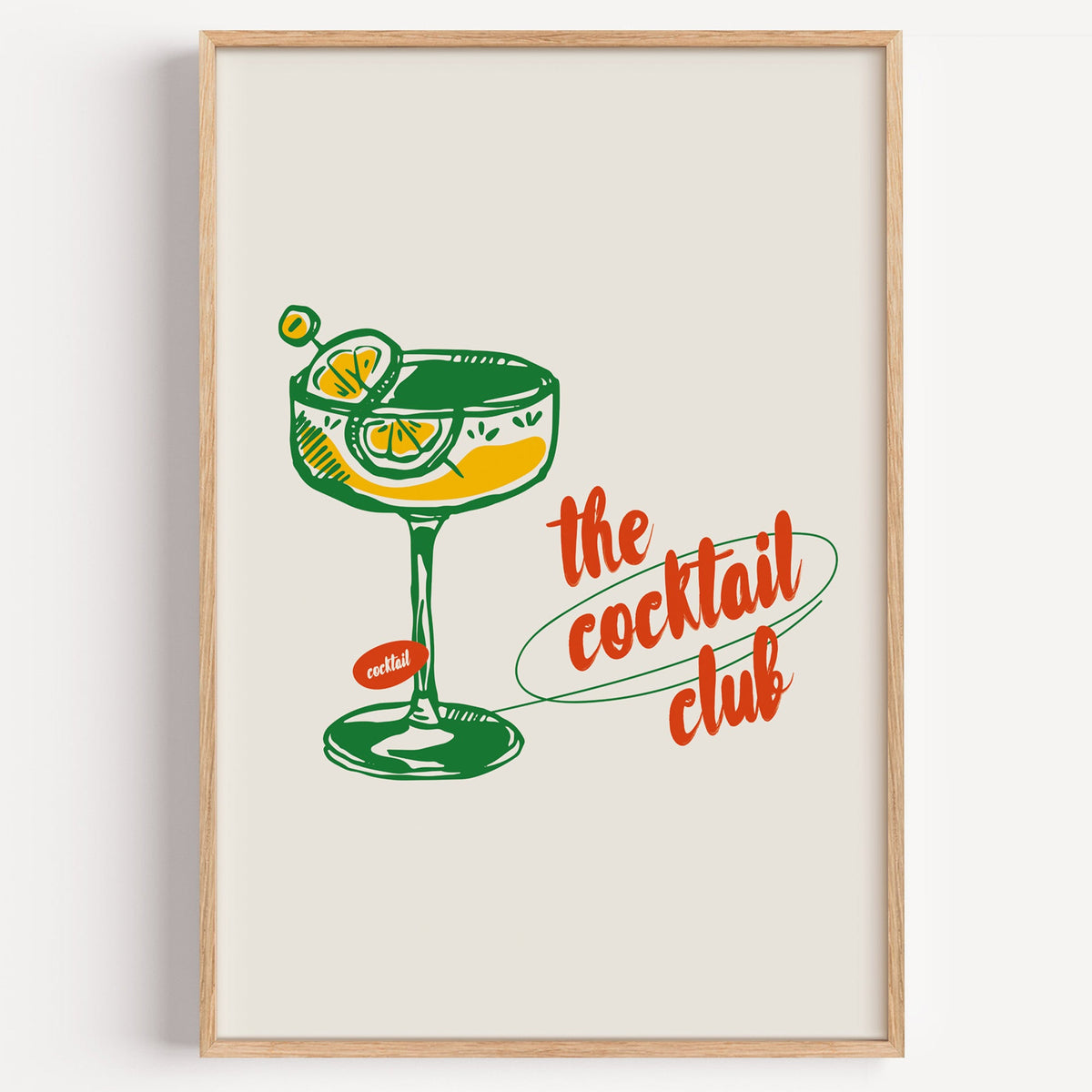 The Cocktail Club coupe glass poster in an oak frame on a plain white wall