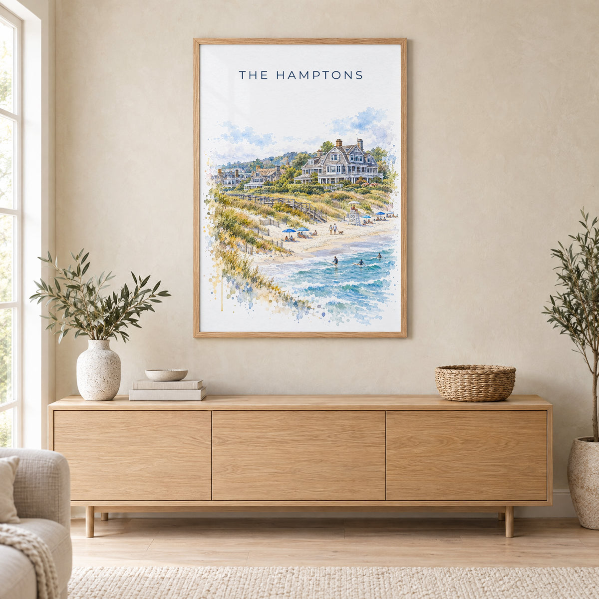 The Hamptons watercolor print in an oak frame above a light wood sideboard in a Scandinavian living room