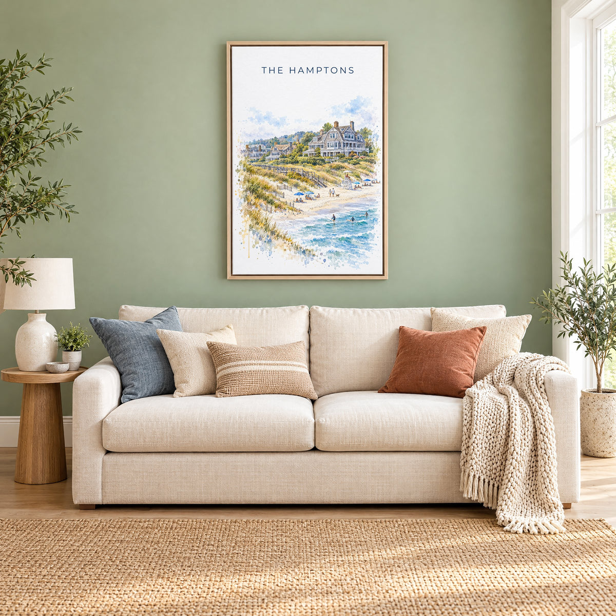The Hamptons watercolor print as a natural floater canvas above a cream linen sofa on a sage green wall