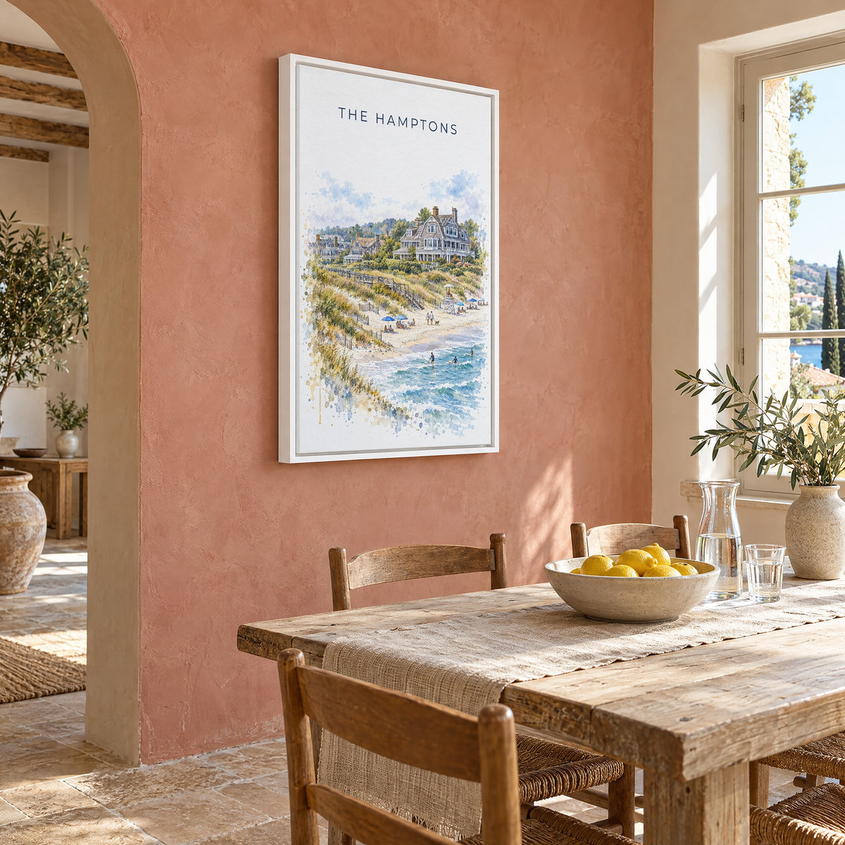 The Hamptons watercolor print as a white floater canvas on a terracotta wall above a rustic dining table