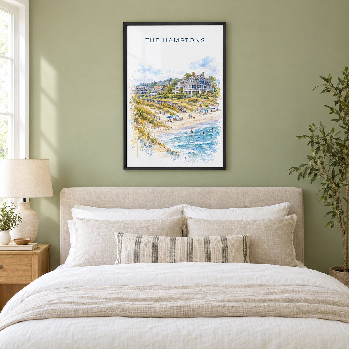 The Hamptons watercolor print in a black frame above an upholstered headboard in a sage green bedroom
