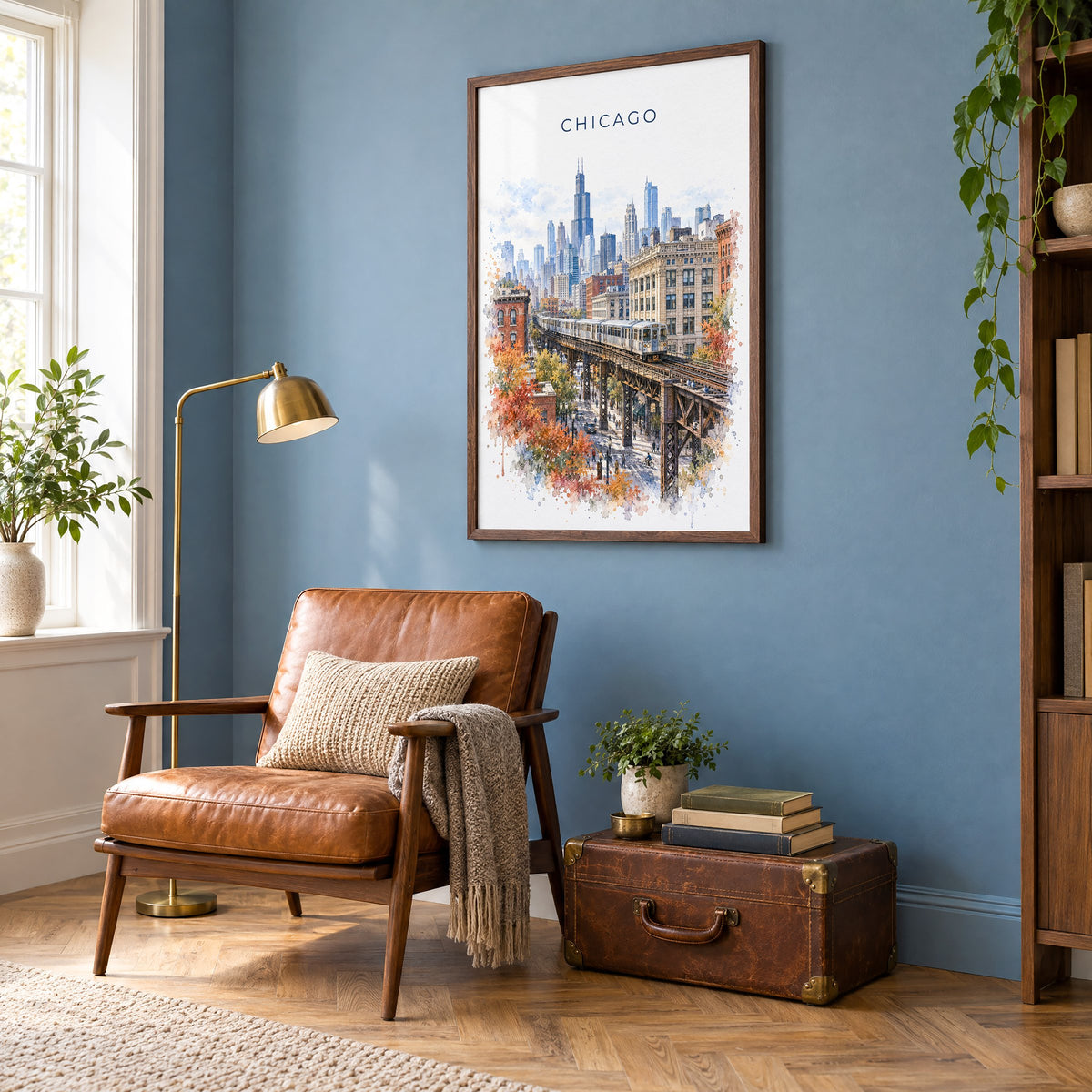 Chicago Loop watercolor print in a walnut frame on a blue wall above a leather armchair in a reading nook