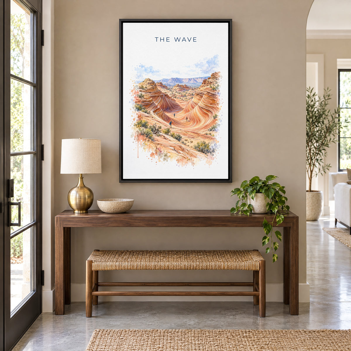 The Wave, Arizona watercolor print as a black floater canvas above a walnut console and woven bench in an entryway