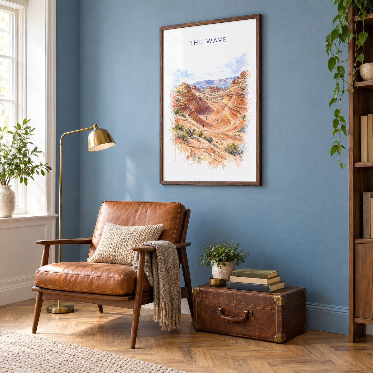 The Wave, Arizona watercolor print in a walnut frame on a blue wall above a leather armchair in a reading nook