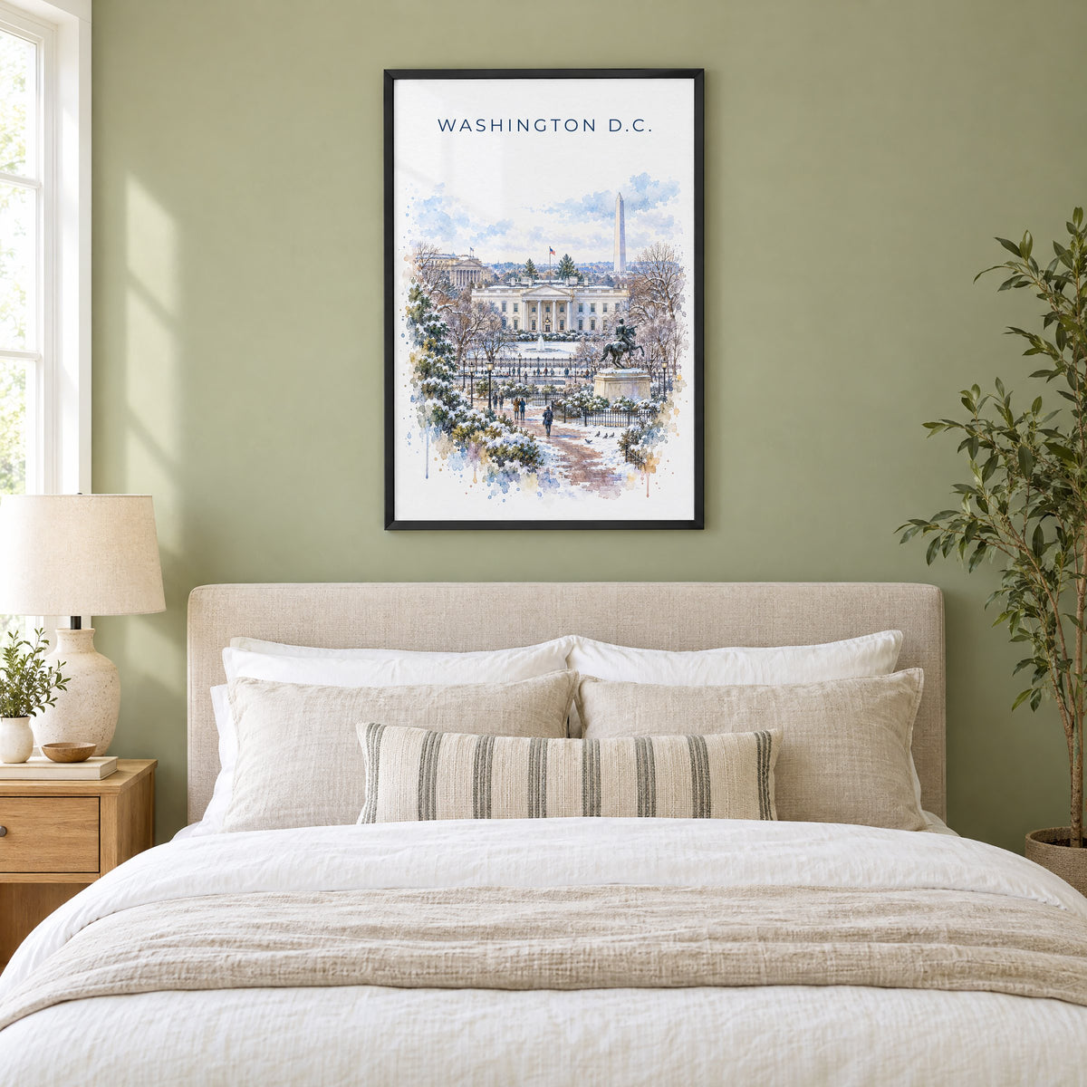 White House watercolor print in a black frame above an upholstered headboard in a sage green bedroom