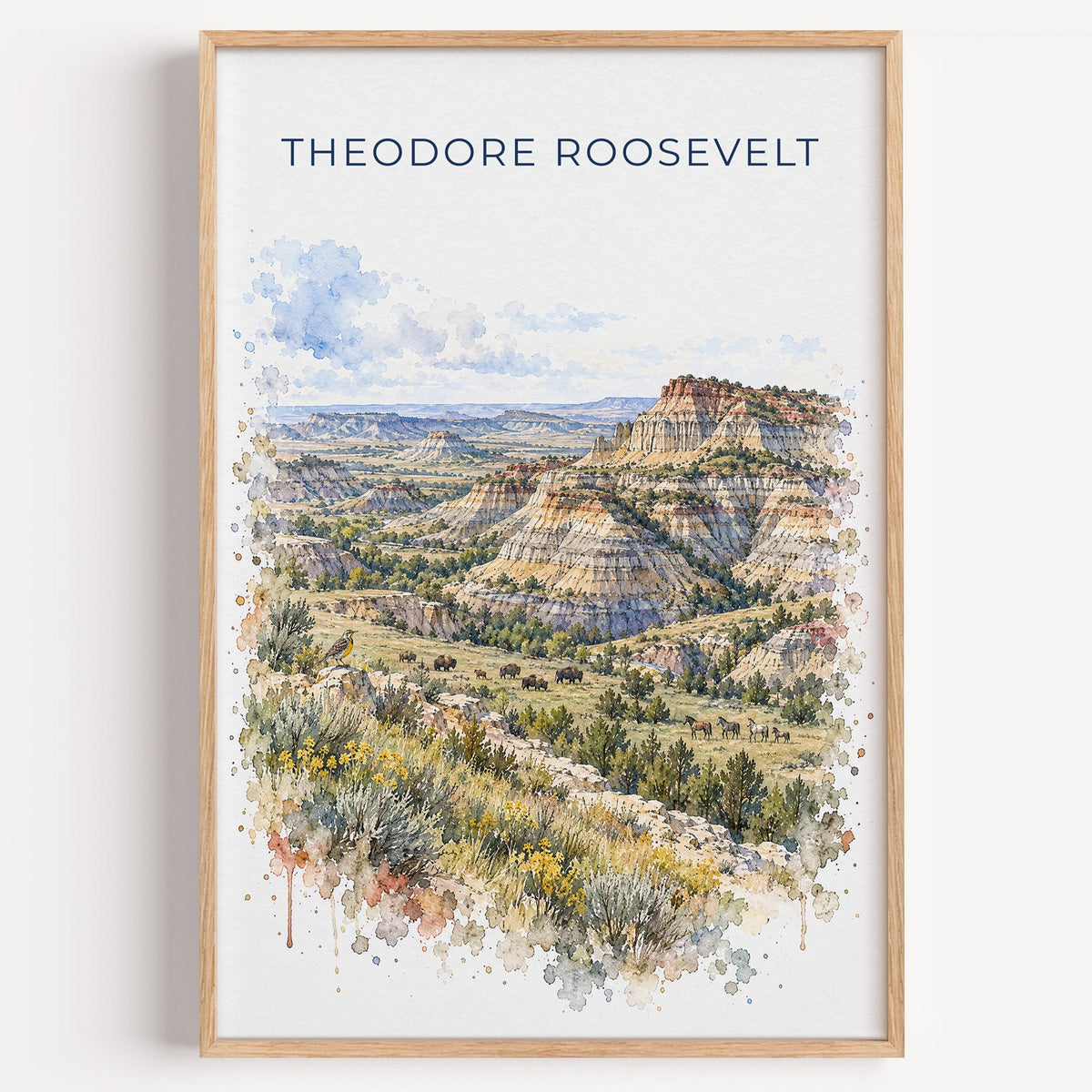 Theodore Roosevelt National Park watercolor print in a light oak frame on a plain white wall
