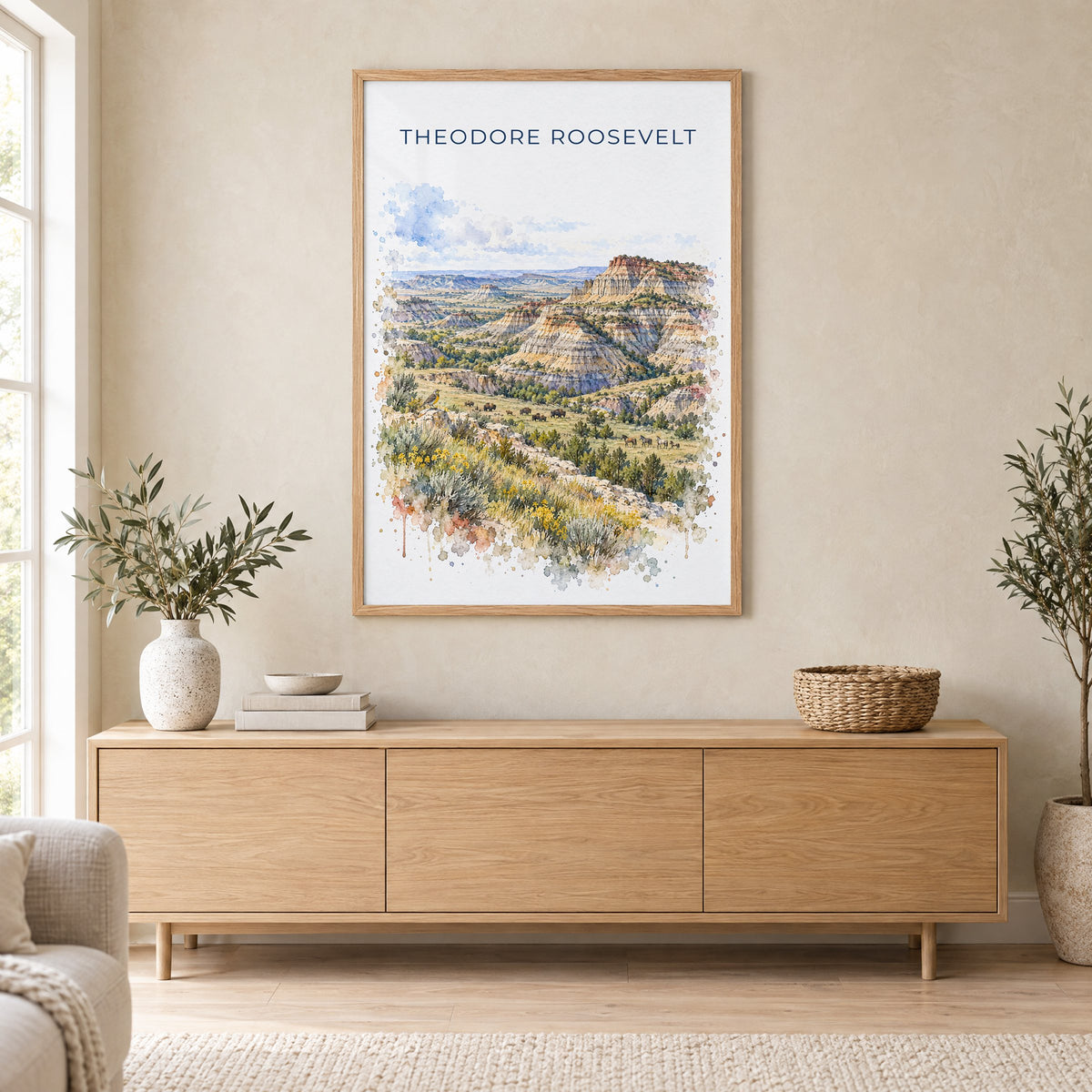 Theodore Roosevelt National Park watercolor print in an oak frame above a light wood sideboard in a Scandinavian living room