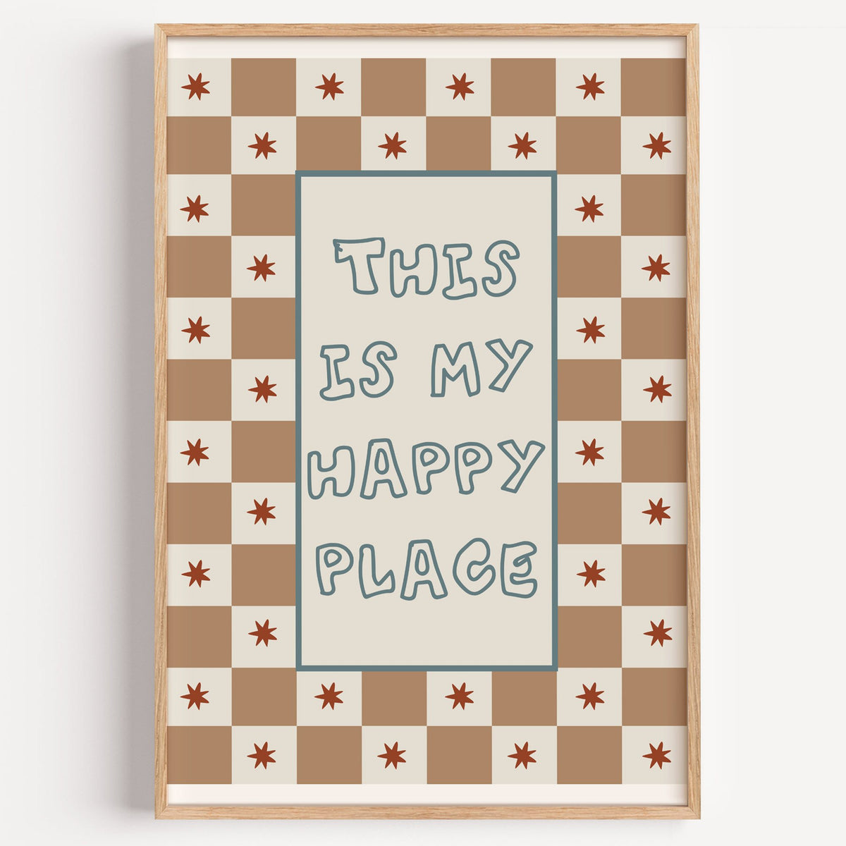 This is my happy place nursery print in a light oak frame on a plain white wall